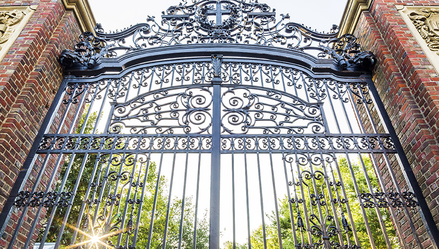 BOSTON, USA - AUGUST 9: the historic architecture of the Harvard University in Cambridge, Massachusetts, USA showcasing its fancy iron gate at sunrise on August 9, 2016.