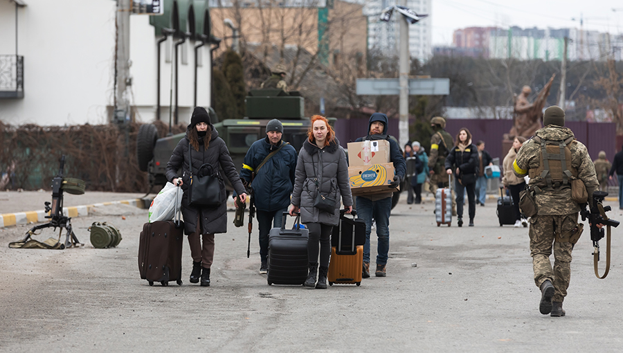 IRPIN, UKRAINE - Mar. 05, 2022: War in Ukraine. Women, old people and children evacuated from Irpin town was transferd to Kyiv by Kyiv territorial defense battalion. War refugees in Ukrain