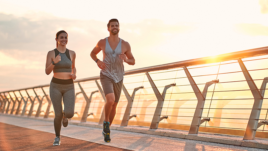 Couple doing sport together on the street. Morning run