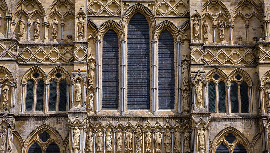 Detail of the main facade of Salisbury Cathedral. Highlights its magnificent sculptures and stained glass