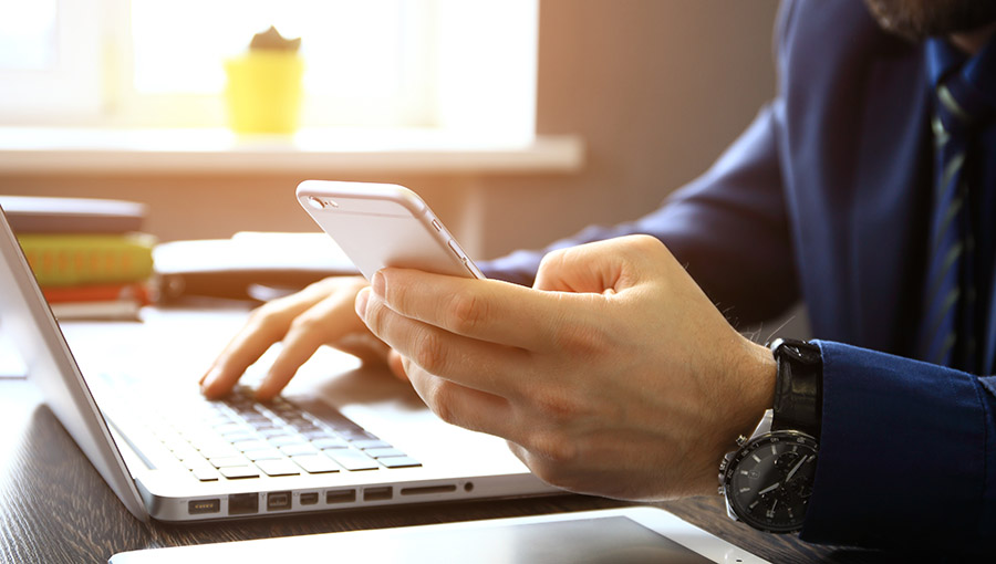 Young businessman working with modern devices, digital tablet computer and mobile phone.