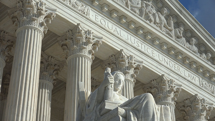 WASHINGTON, DC - OCT 3, 2016:   Equal Justice Under Law engraving above entrance to US Supreme Court Building.  Supreme Court faces the US Capitol Building.