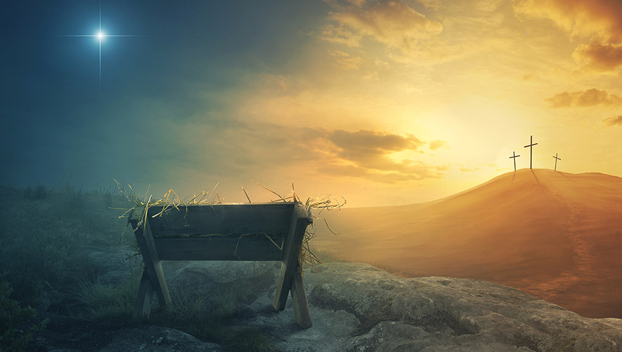 A wooden manger and three wooden crosses