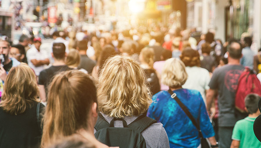 Unrecognizable mass of people walking in the city