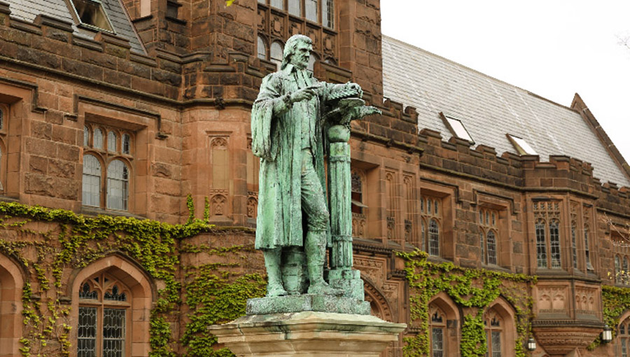 Princeton, New Jersey - April 22, 2016: View of the facade of East Pyne Building and a statue of Princeton University President John Witherspoon on the Princeton University campus, New Jersey, USA.