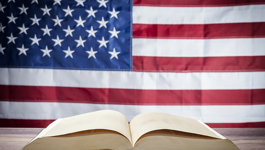 Opened book on a background of the USA flag